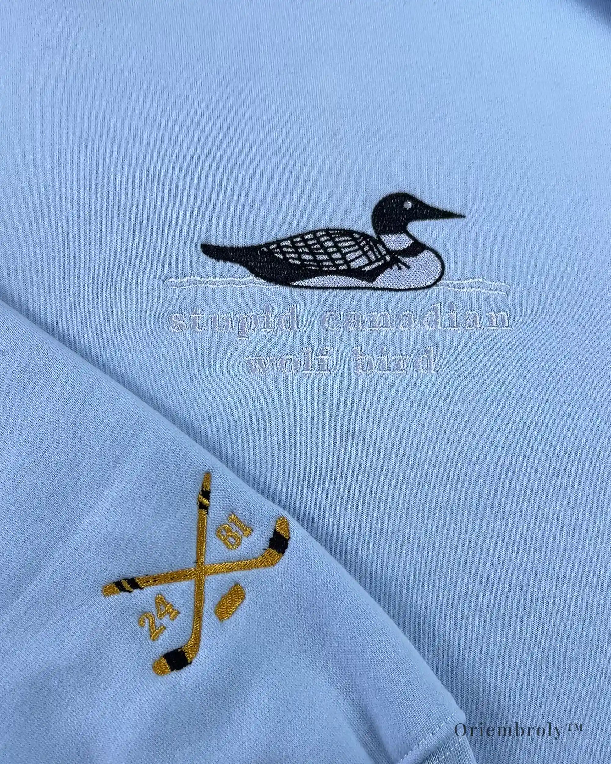 Stupid canadian wolf bird text embroidery close-up