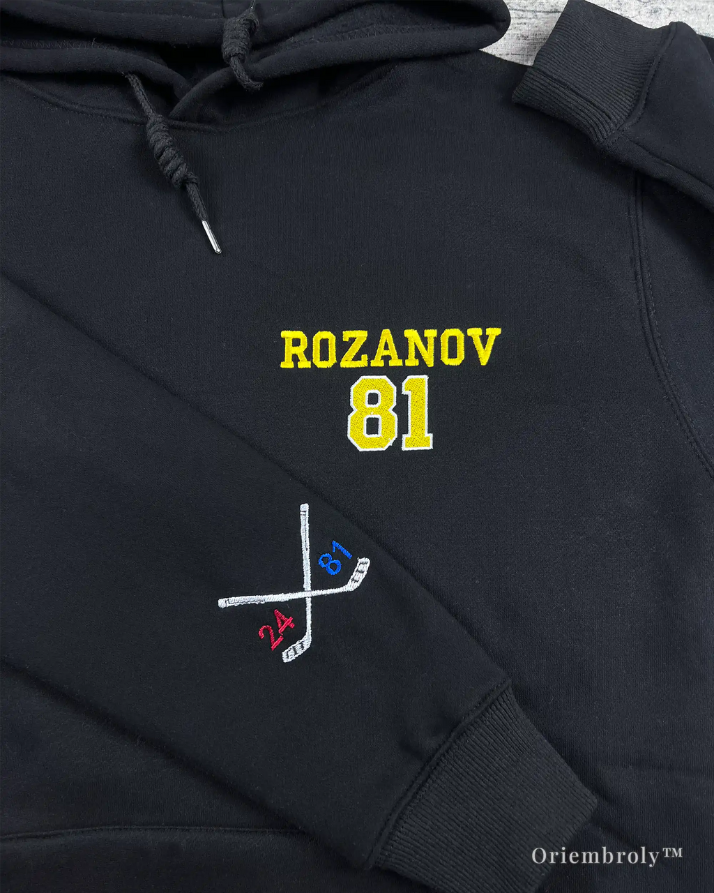crossed hockey sticks sleeve embroidery on black hoodie