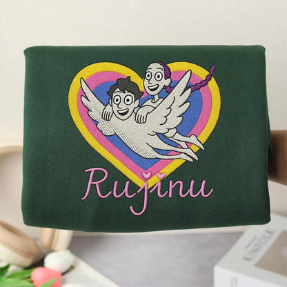 Green bag with embroidered design and 'Rujinu' text on a light background