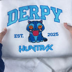 White sweatshirt with blue embroidered text and a cartoon character on a white background