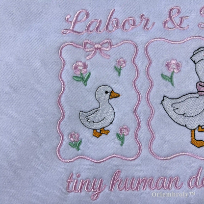 Perfect L&D nurse gift idea: White embroidered sweatshirt with a "baby delivery" goose theme