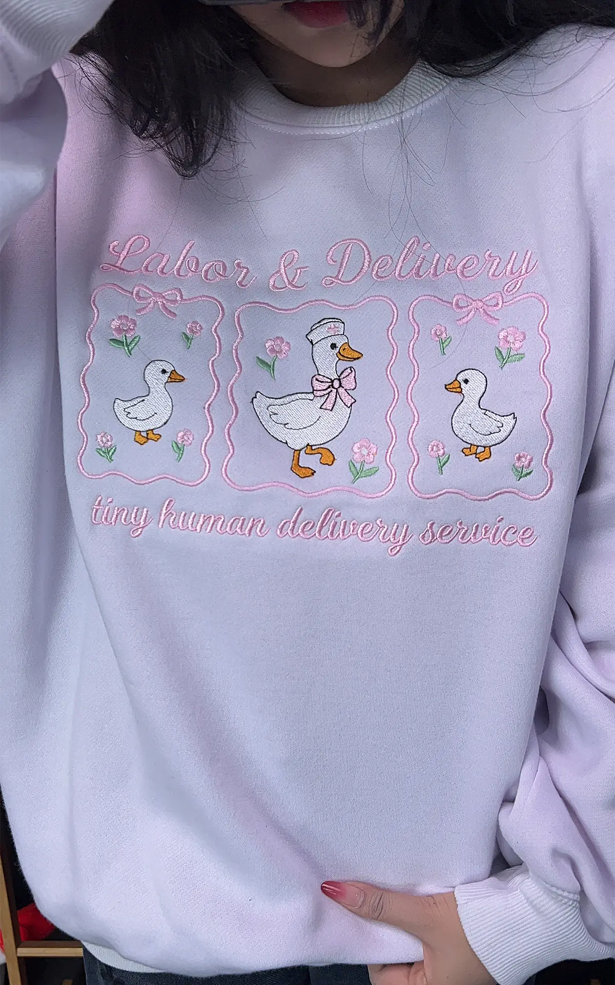 Labor and Delivery nurse merch: White sweatshirt with vibrant pink embroidery and nursery vibes