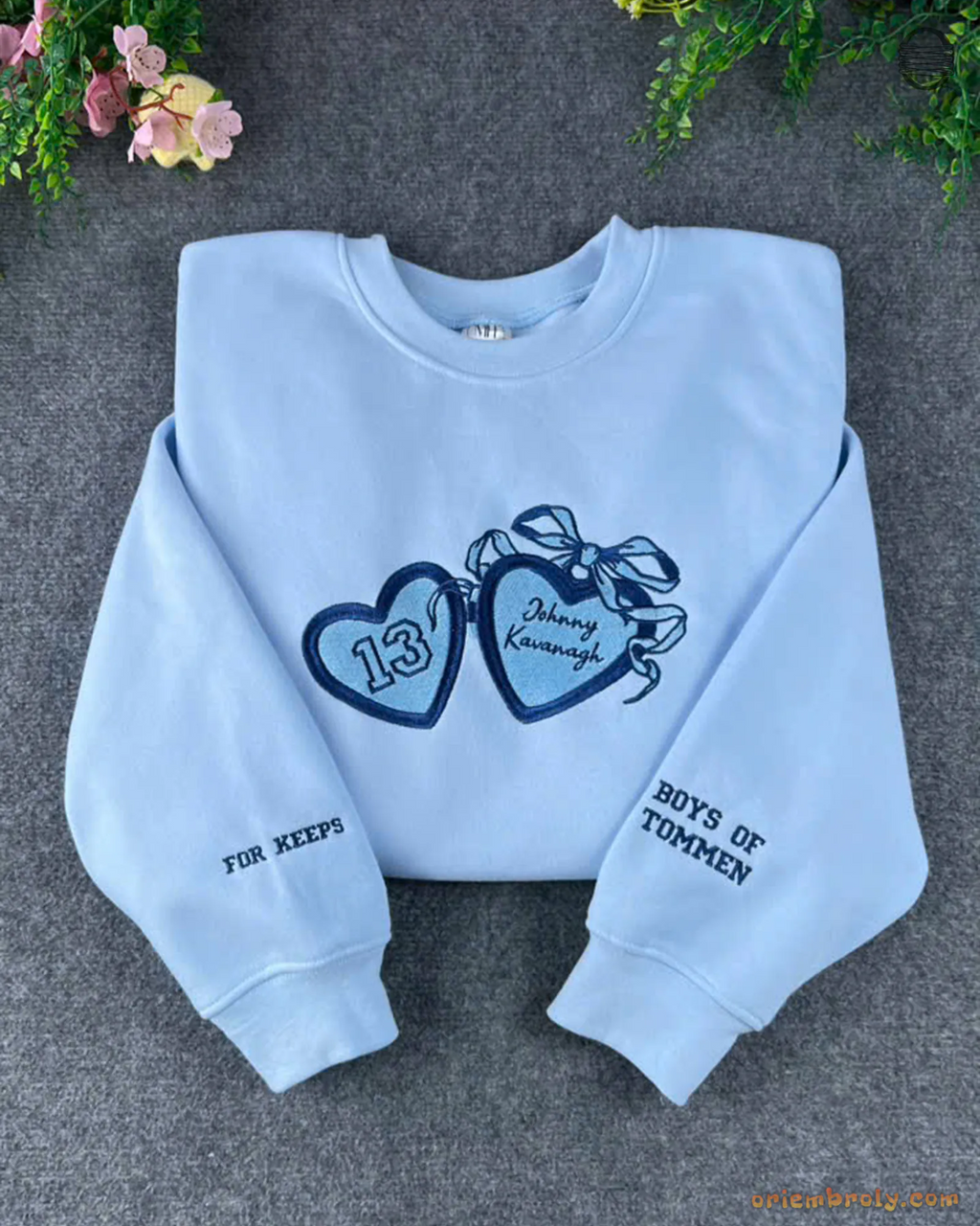 Light blue crewneck sweatshirt featuring dark blue embroidered bow hearts and Best of Friends sleeve detail