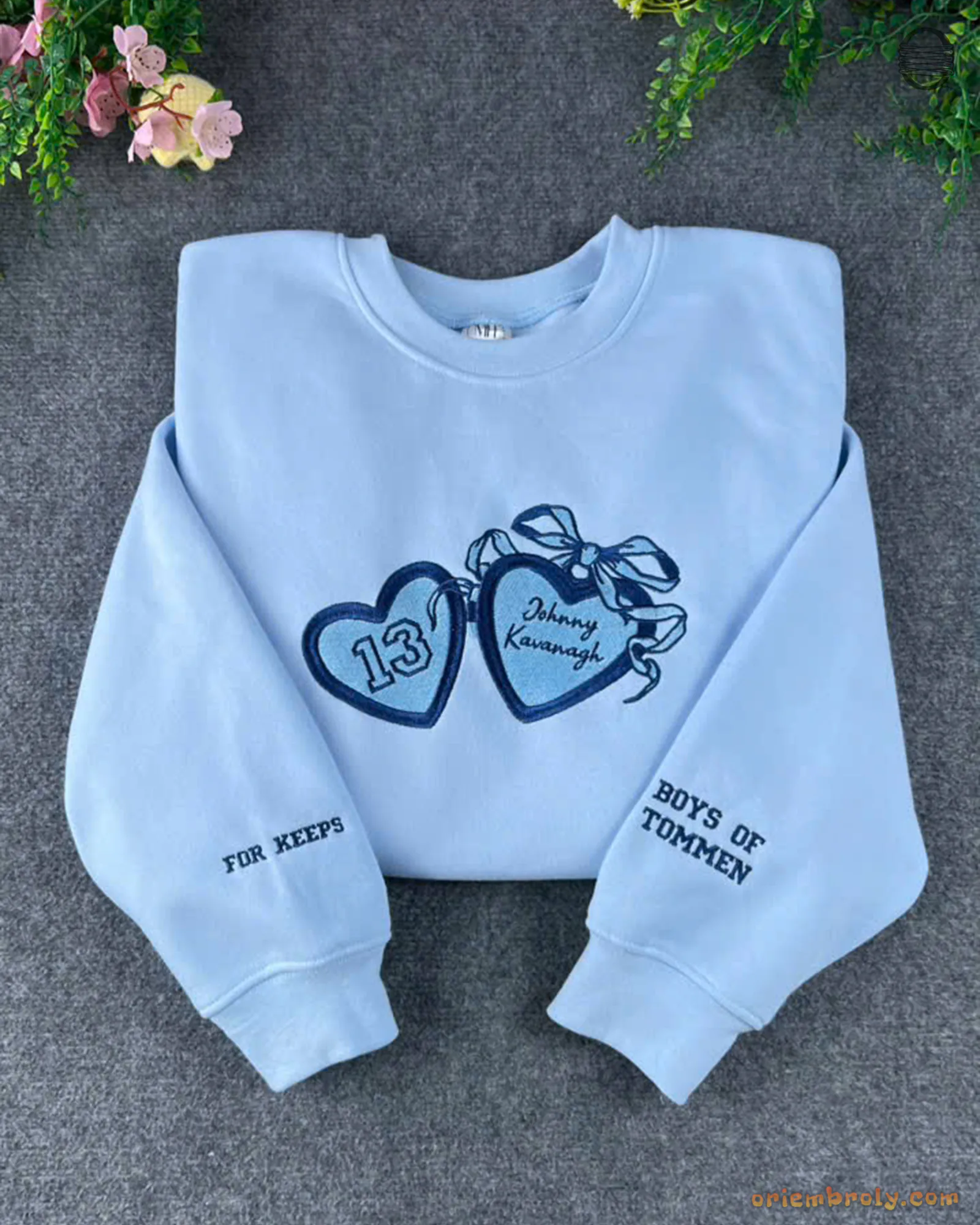 Light blue crewneck sweatshirt featuring dark blue embroidered bow hearts and Best of Friends sleeve detail