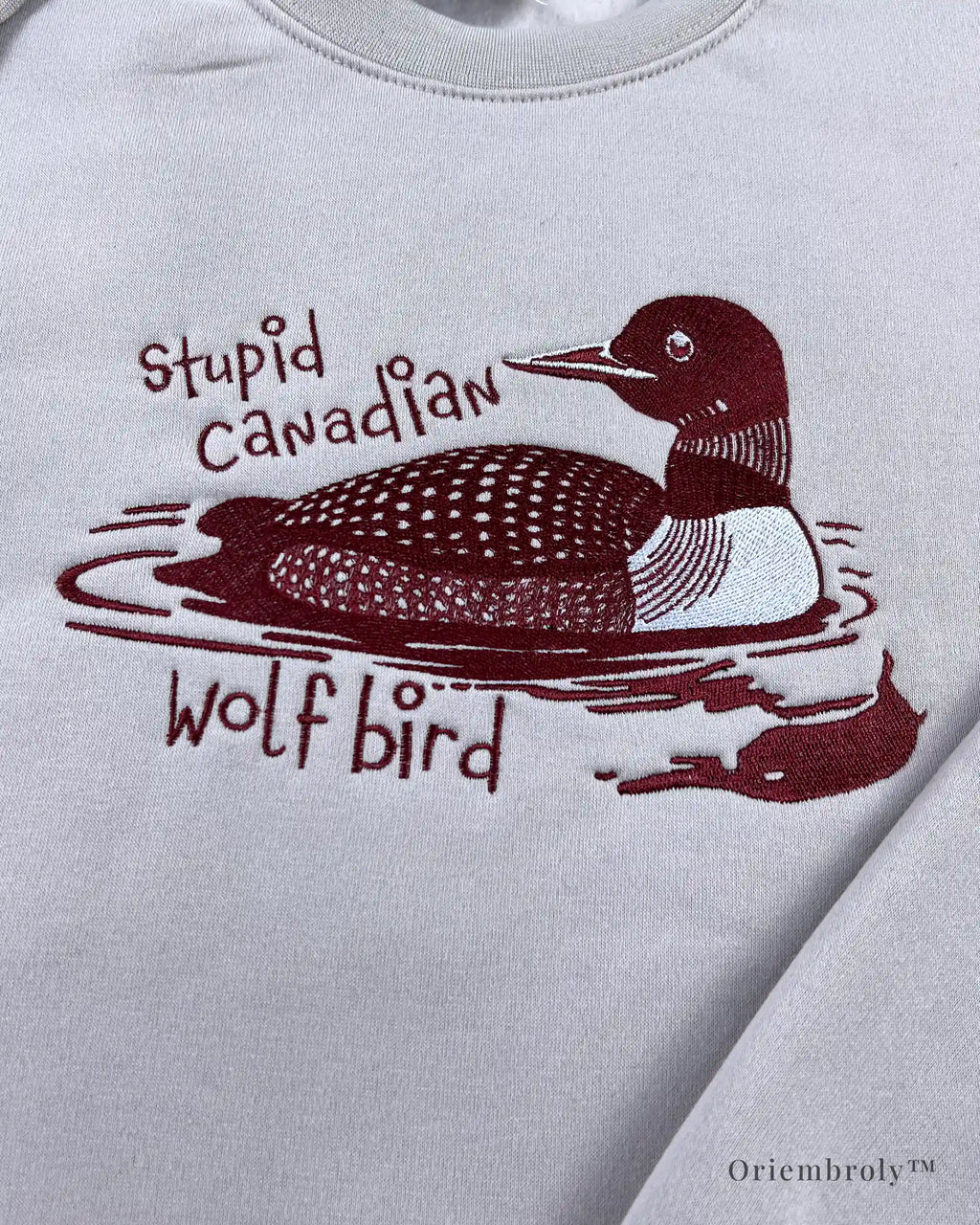 Embroidered loon floating on water detail