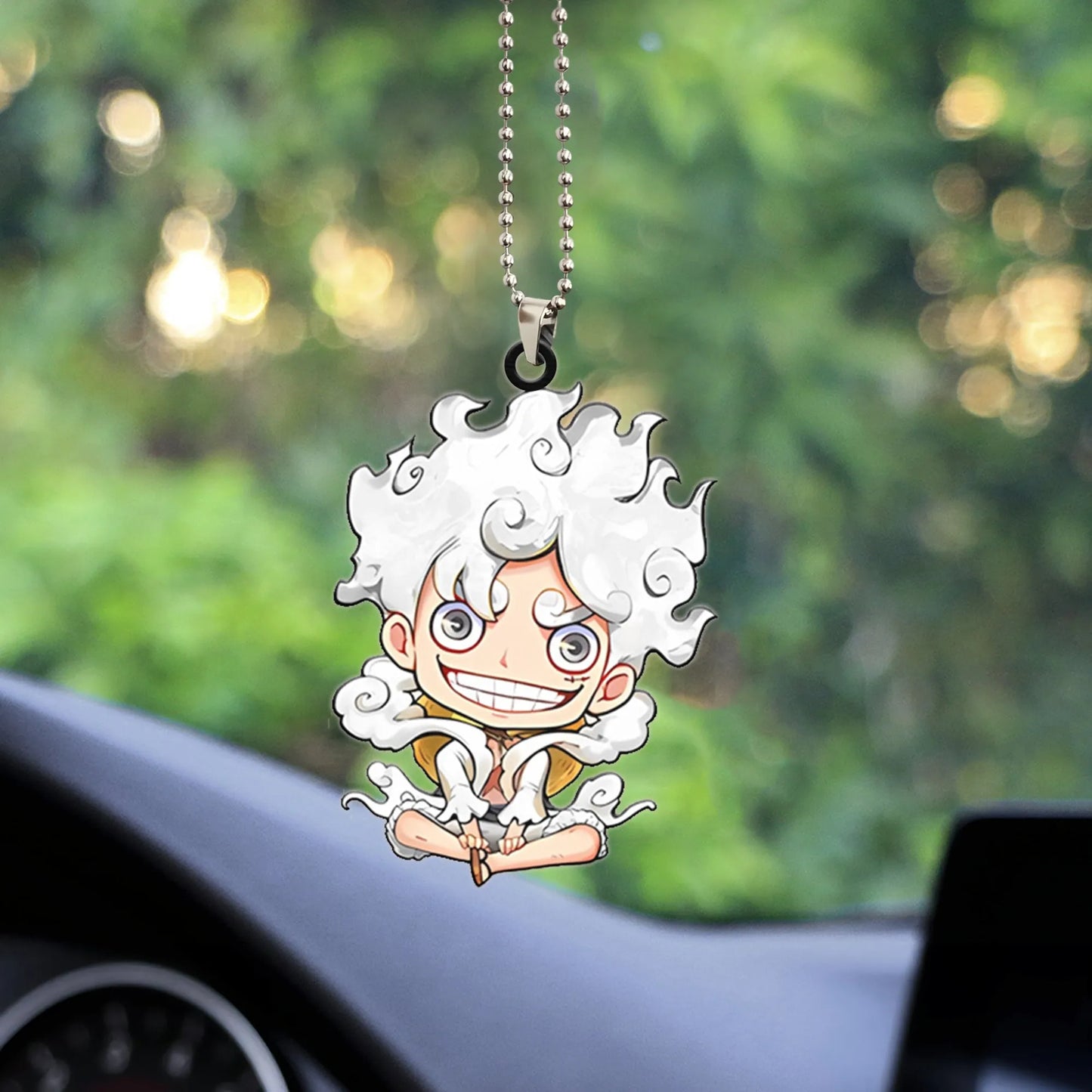 A small, chibi-style hanging ornament of Monkey D. Luffy from the anime One Piece, depicted in his white-haired Gear 5 (Sun God Nika) form with a large smile and cloud accents. The figure is hanging by a silver ball chain, often used as a car rearview mirror accessory or general anime collectible