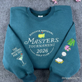 Premium teal crewneck sweatshirt featuring high-quality Masters Tournament 2026 Augusta National embroidery. A must-have souvenir for golf fans and tournament enthusiasts