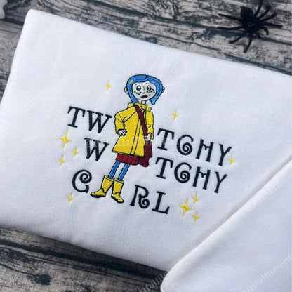 Embroidered design of a character with text on a white fabric background