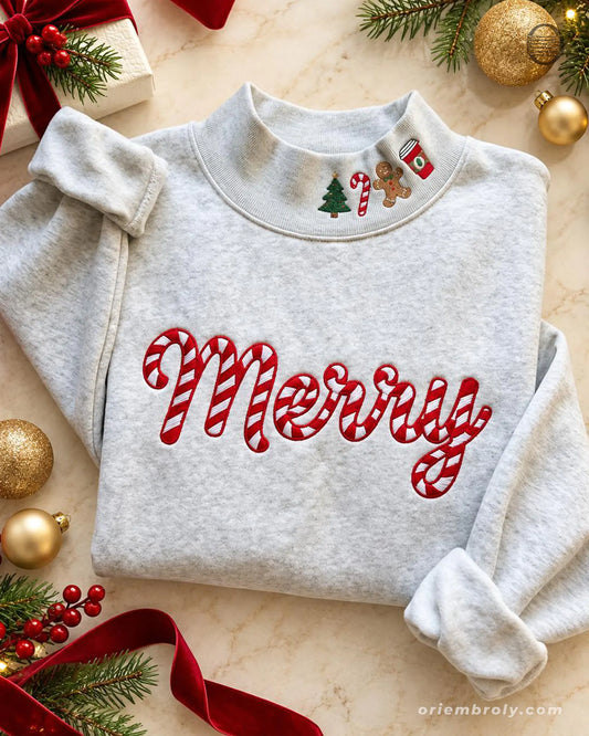 Flat lay of an ash grey crewneck sweatshirt embroidered with red candy cane Merry chest text and cute Christmas collar icons