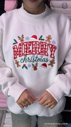 Overview of a white holiday embroidered crewneck sweater with plaid text and winter festive details