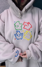 Minimalist Nintendo-inspired apparel: White hoodie with embroidered Luma icons in primary colors.