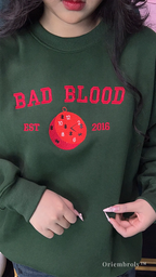 mystery reader wearing embroidered bookish sweatshirt