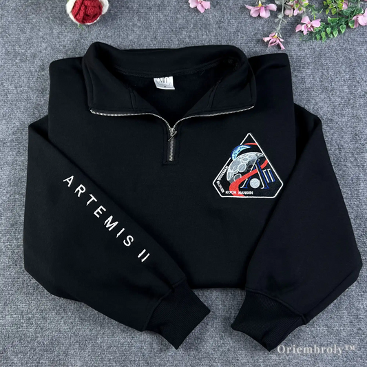 High-quality black quarter-zip sweatshirt featuring the official NASA Artemis II moon mission patch and sleeve embroidery. Durable satin stitch design for space exploration enthusiasts and NASA fans