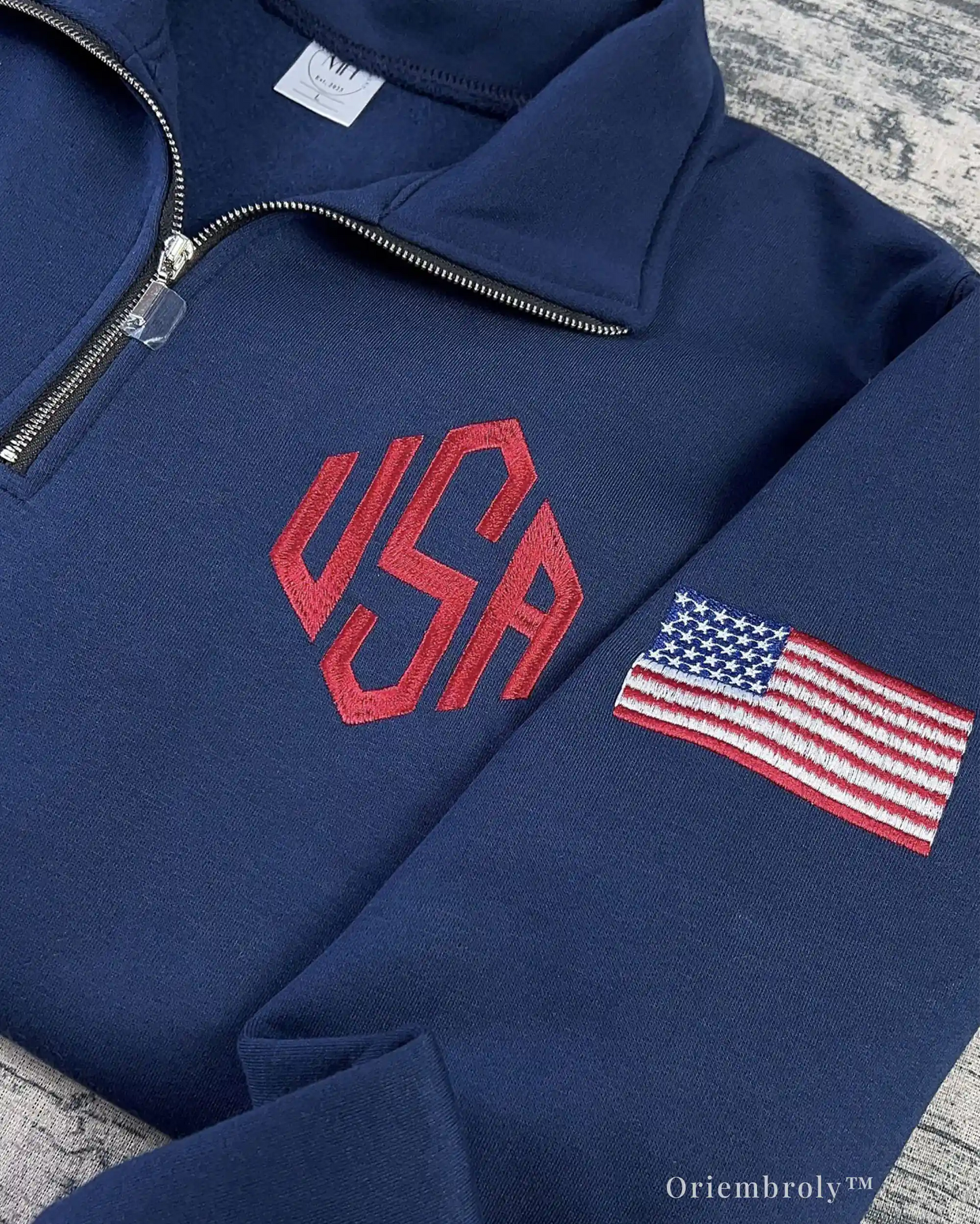 navy embroidered quarter zip sweatshirt flat lay