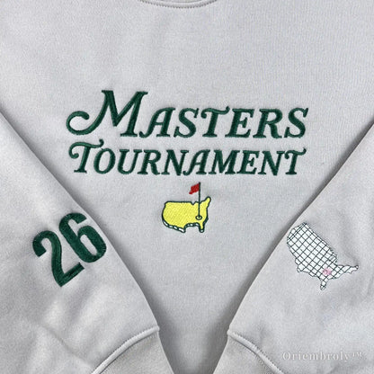 Old money golf aesthetic cream sweatshirt with detailed Masters embroidery and USA map sleeve patches. A perfect preppy country club style pullover for a sophisticated casual look