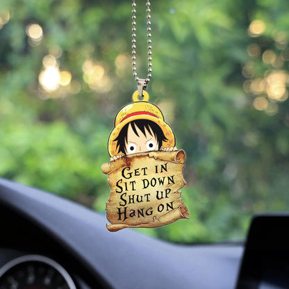 A One Piece anime car ornament or keychain featuring the character Monkey D. Luffy peeking over a scroll with the funny text "GET IN SIT DOWN SHUT UP HANG ON" written on it. This item is also sold as a necklace or part of a jewelry set.