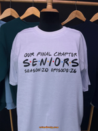 White t-shirt with 'Our Final Chapter Seniors' text on a mannequin against a dark background.