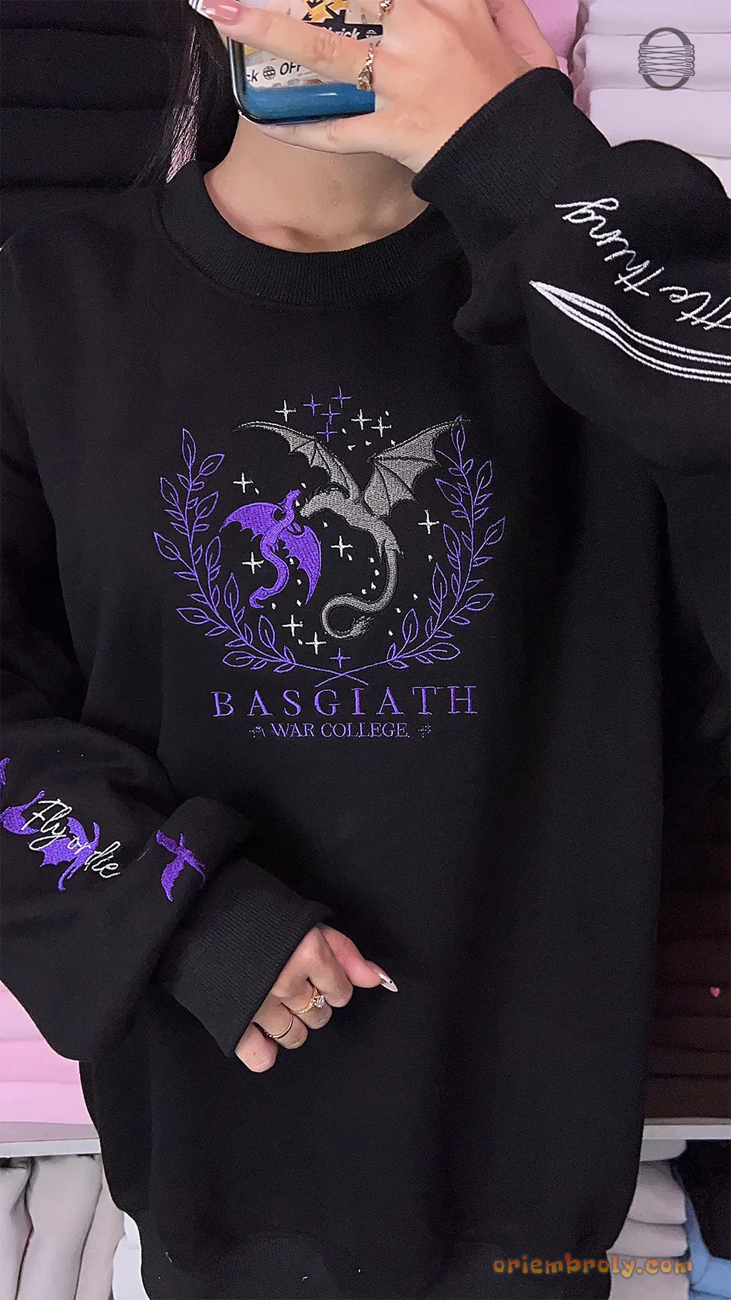 Model wearing an oversized black Basgiath War College Fourth Wing embroidered crewneck sweater with detailed sleeve embroidery