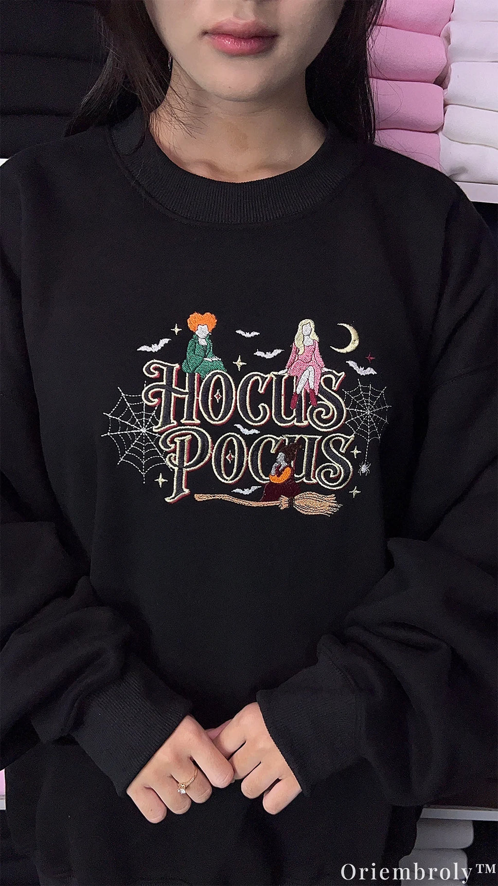Model wearing an oversized black Hocus Pocus embroidered sweatshirt for Halloween spooky season