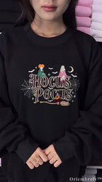 Model wearing an oversized black Hocus Pocus embroidered sweatshirt for Halloween spooky season