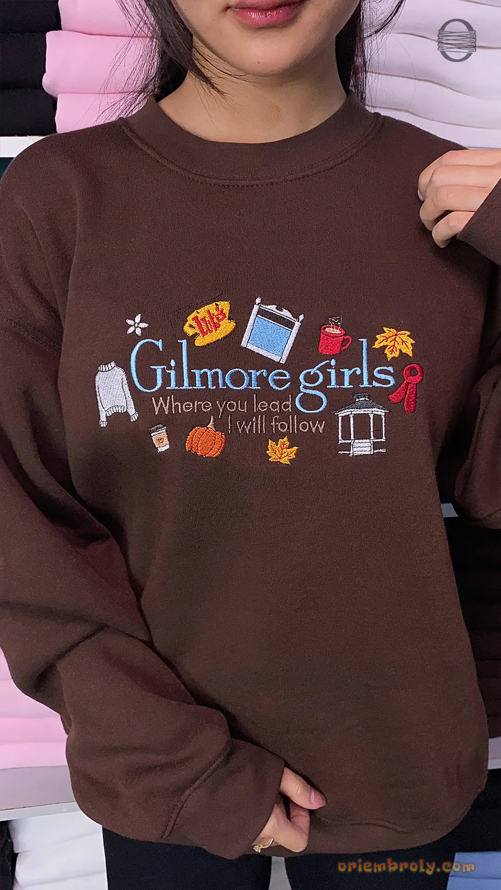 Model wearing an oversized chocolate brown Gilmore Girls embroidered crewneck sweatshirt for fall outfit