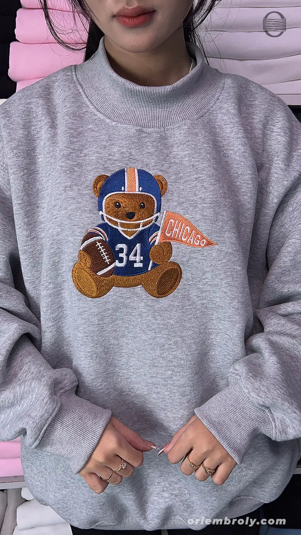 Model wearing an oversized sport grey Chicago football bear number 34 embroidered crewneck sweater for game day outfit