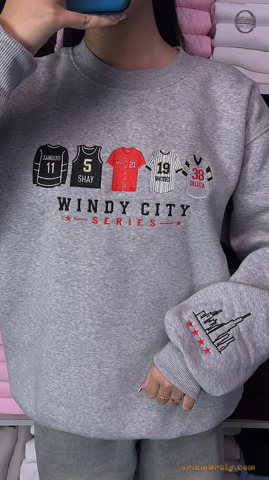 Model wearing an oversized heather grey Windy City Series Chicago sports embroidered crewneck sweater