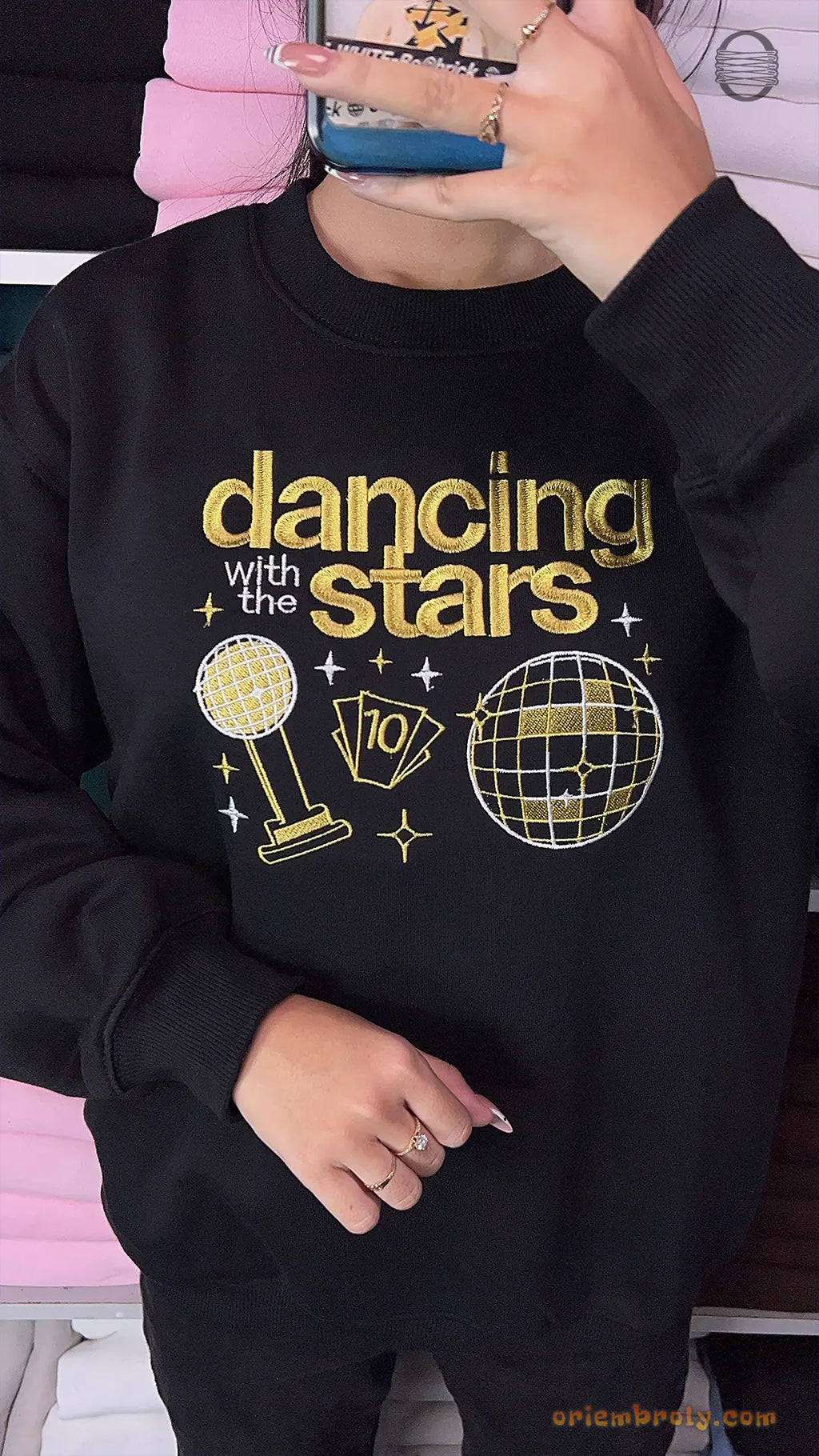 Model wearing an oversized black Dancing with the Stars embroidered crewneck sweater for pop culture outfit