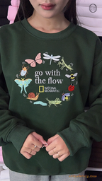 Model wearing an oversized forest green Go With The Flow embroidered crewneck sweater for cottagecore outfit