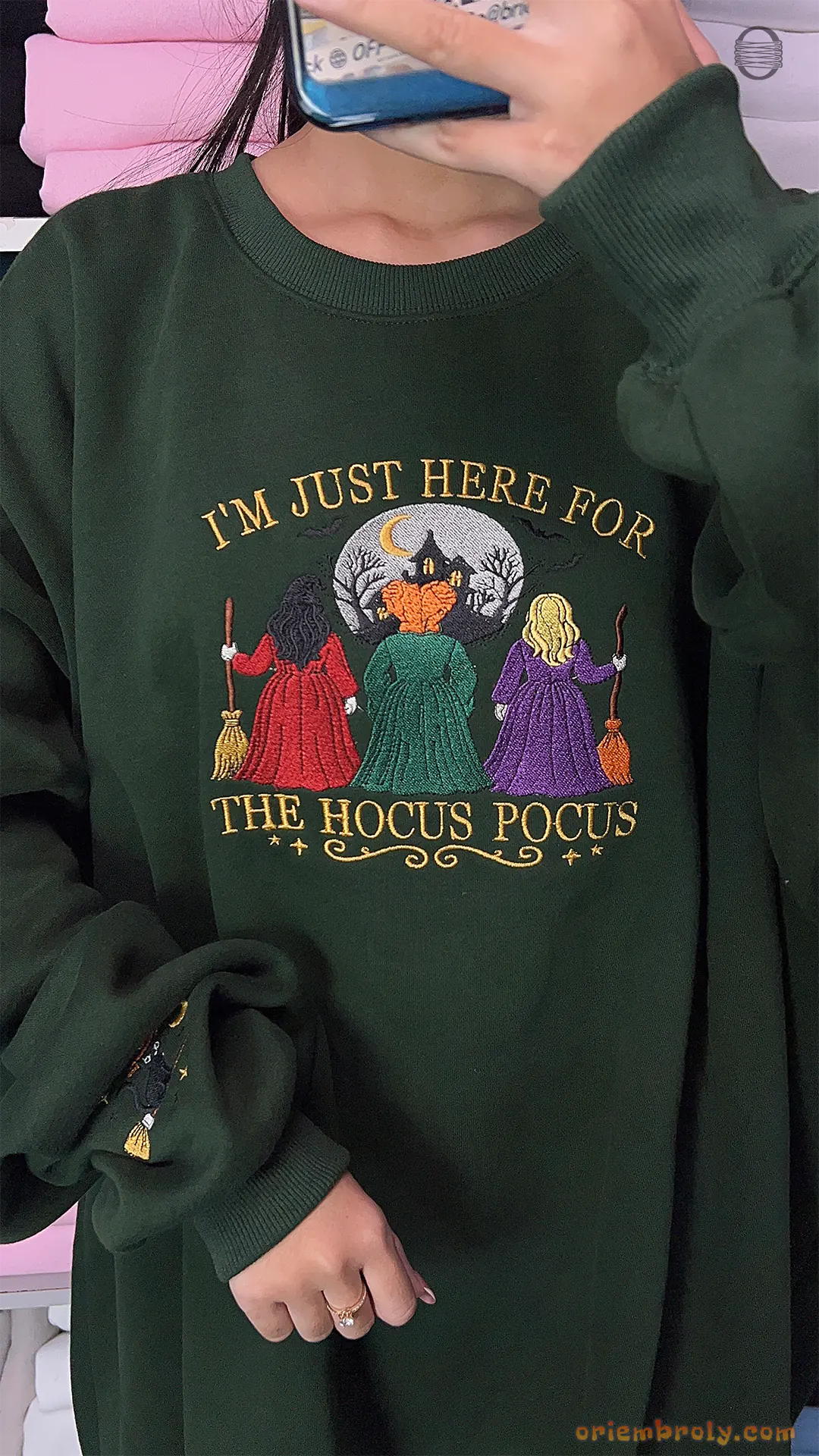 Model wearing an oversized forest green Im Just Here For The Hocus Pocus embroidered sweatshirt