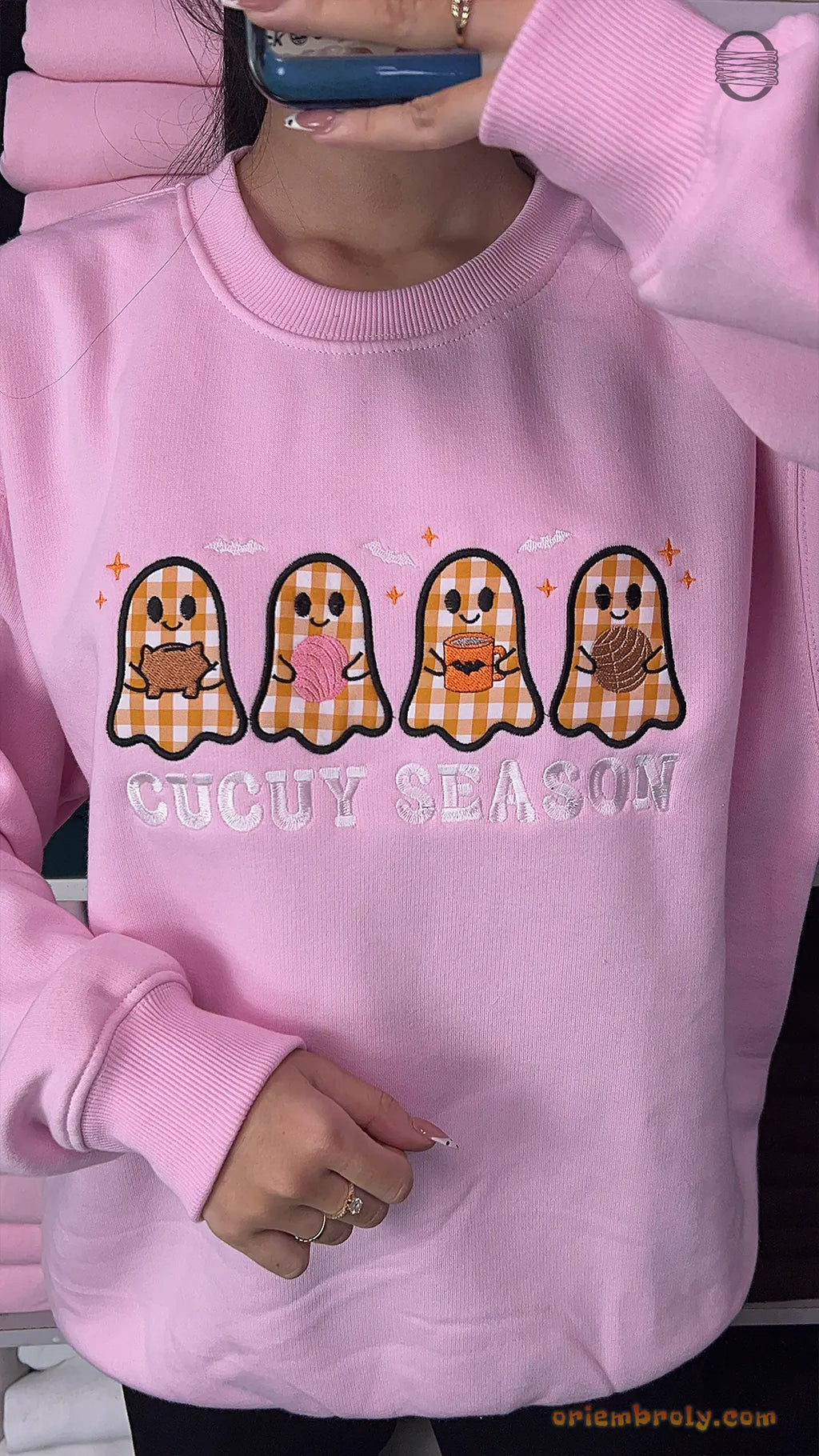 Model wearing an oversized light pink Spooky Season embroidered crewneck sweater for cute Halloween outfit