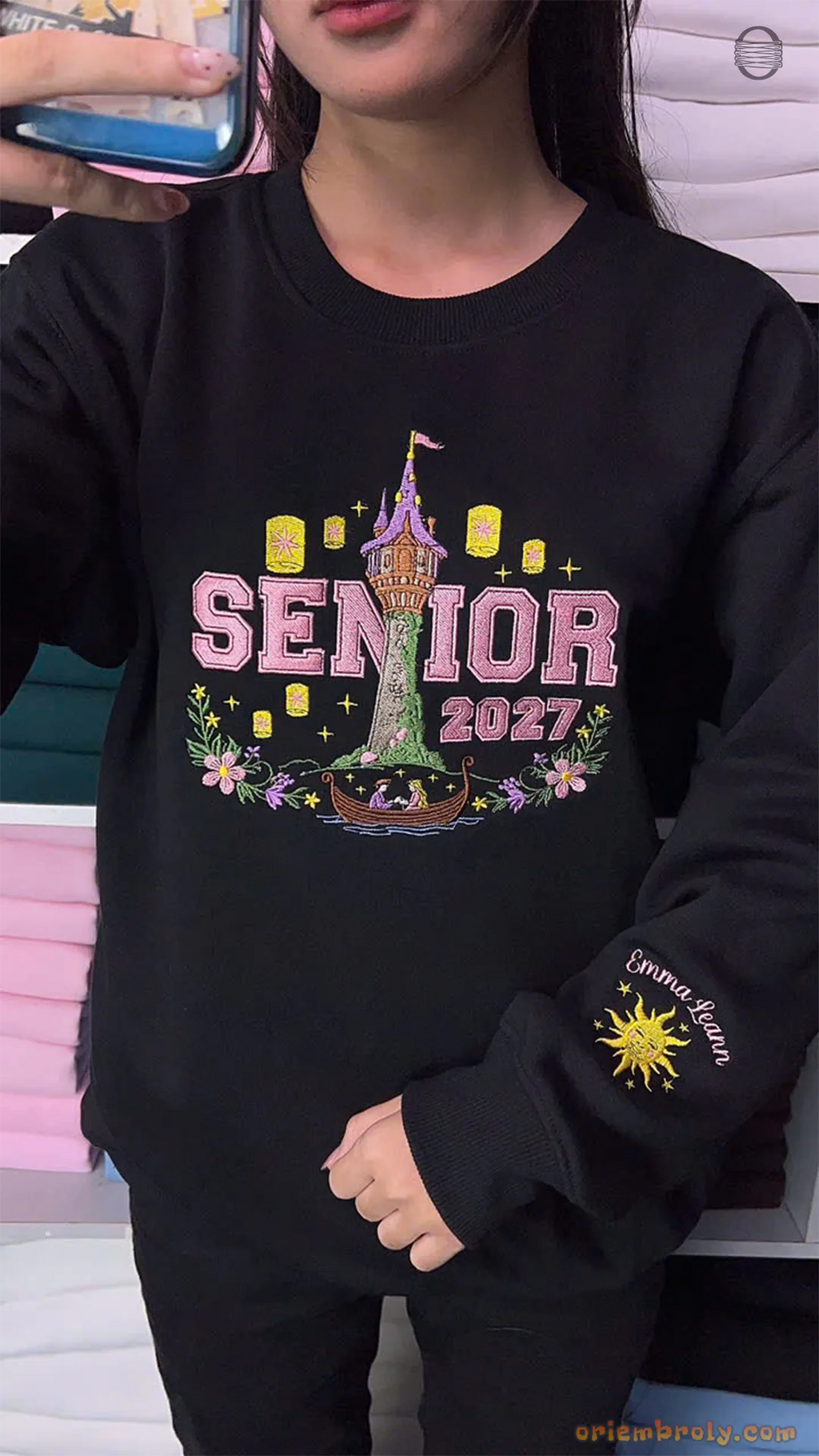 Model wearing an oversized black Senior 2027 embroidered sweatshirt with Rapunzel tower and golden sun sleeve print