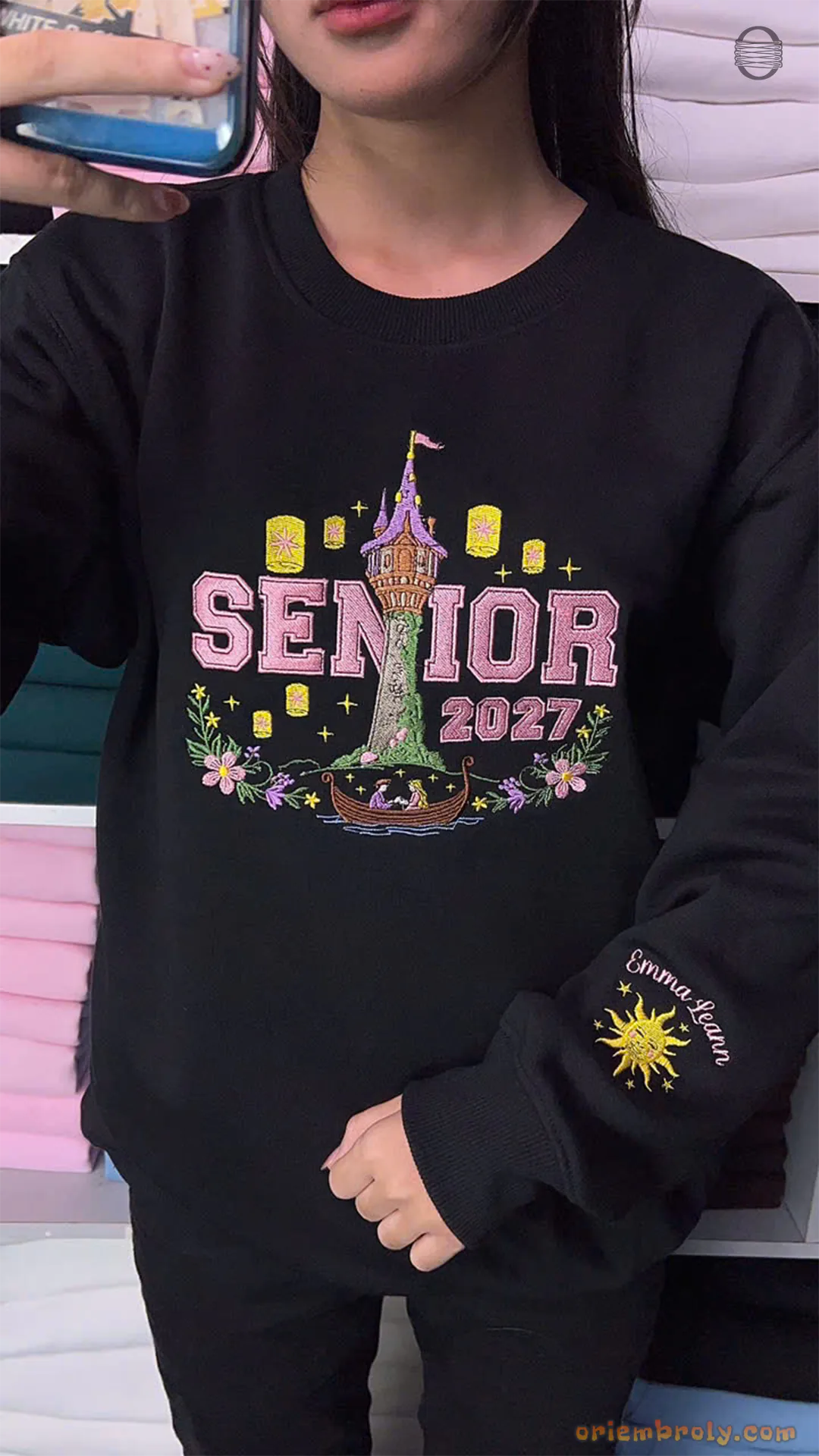 Model wearing an oversized black Senior 2027 embroidered sweatshirt with Rapunzel tower and golden sun sleeve print