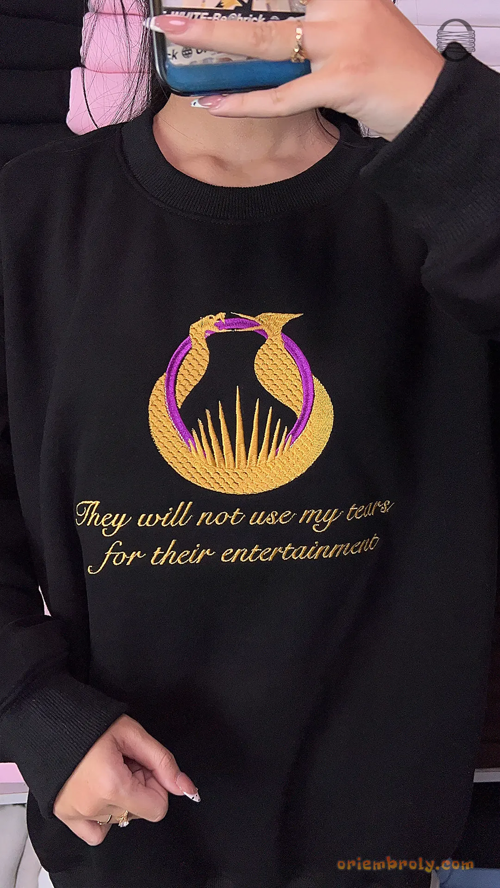 Model wearing an oversized black Hunger Games embroidered crewneck sweater for bookish outfit