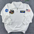 Oversized white quarter-zip with multi-patch NASA embroidery. Modern streetwear piece inspired by vintage 90s space agency merchandise and technical flight gear.