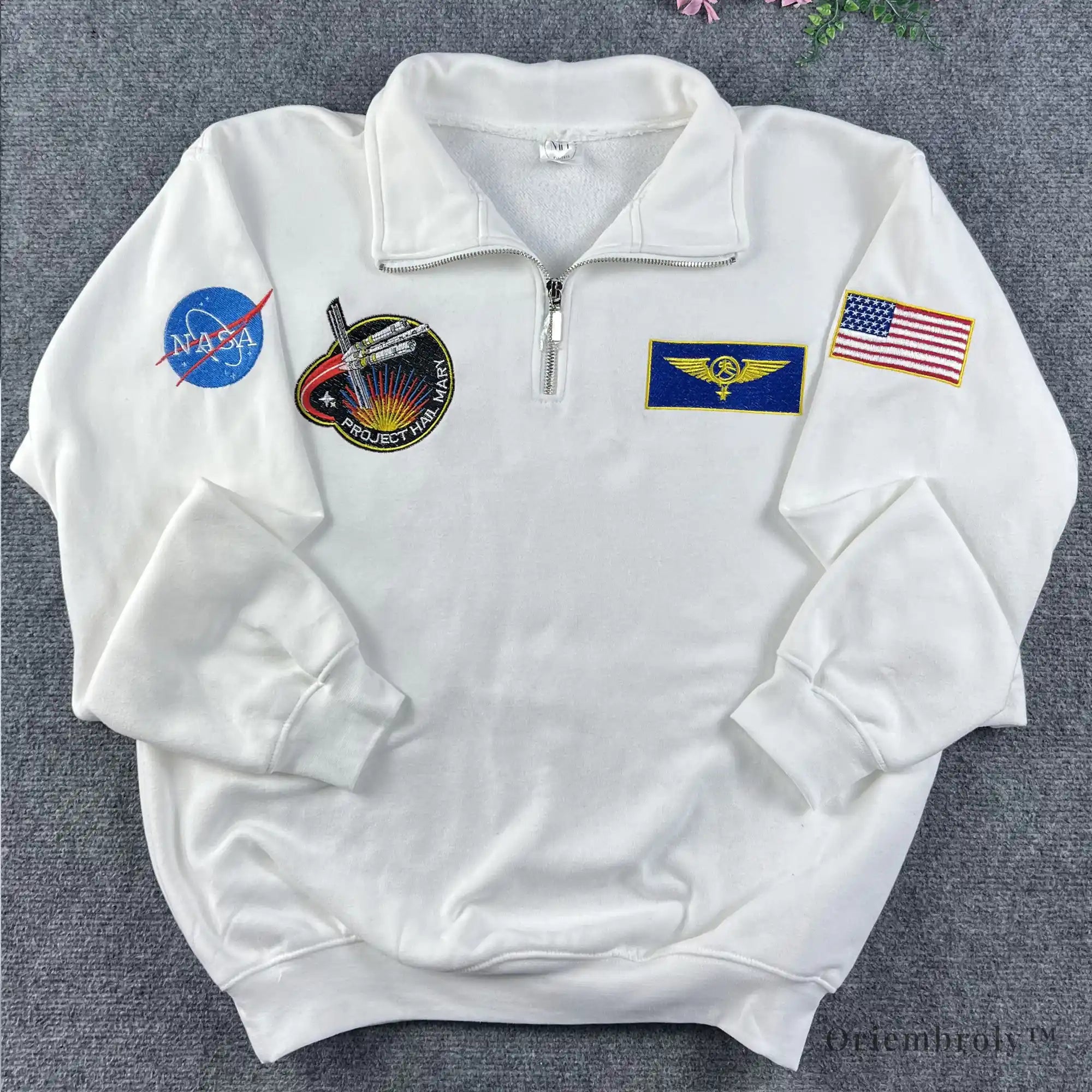 Oversized white quarter-zip with multi-patch NASA embroidery. Modern streetwear piece inspired by vintage 90s space agency merchandise and technical flight gear.