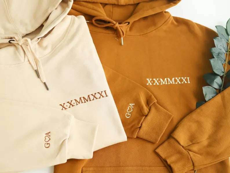 Custom embroidered Roman numeral sweatshirt, a personalized anniversary gift for couples, available in multiple colors.