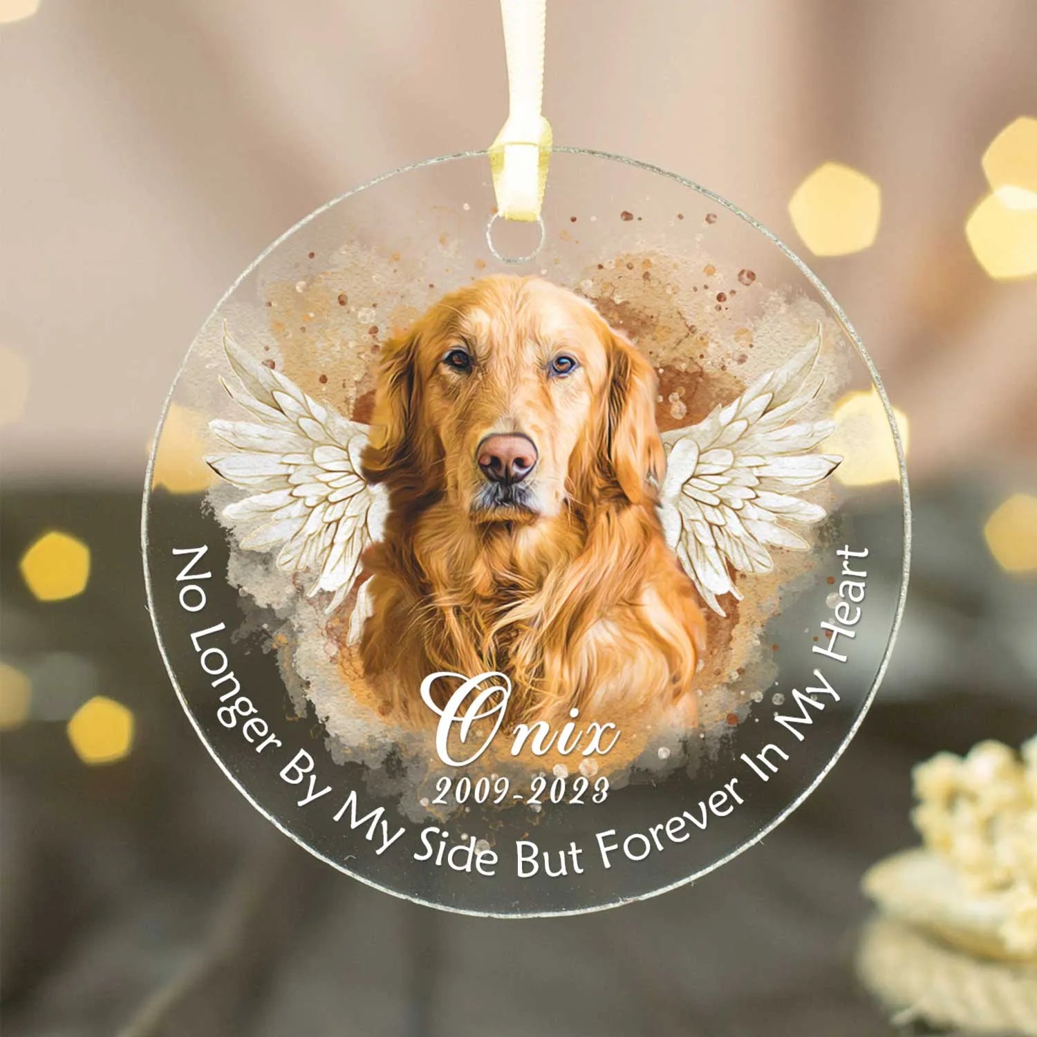 A personalized acrylic pet memorial photo ornament featuring a golden retriever named Onix with angel wings and text that reads 'No Longer By My Side But Forever In My Heart' and the dates 2009-2023.