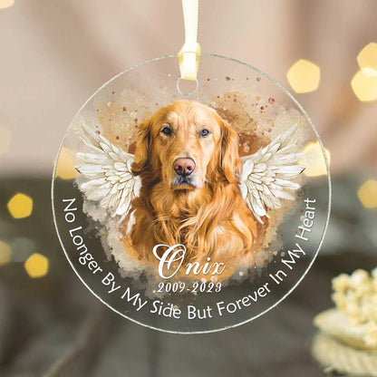 A personalized acrylic pet memorial photo ornament featuring a golden retriever named Onix with angel wings and text that reads 'No Longer By My Side But Forever In My Heart' and the dates 2009-2023.