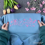 pink bow satin stitch embroidery detail on coquette sweatshirt