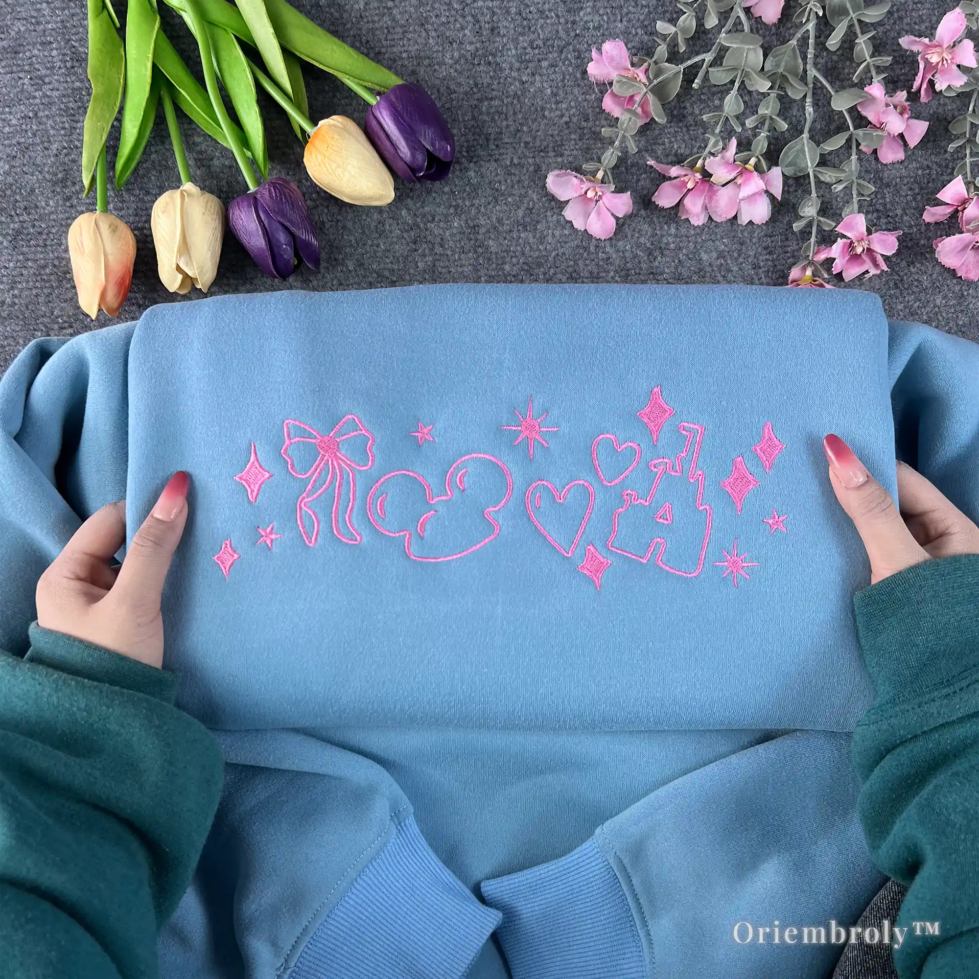 pink bow satin stitch embroidery detail on coquette sweatshirt