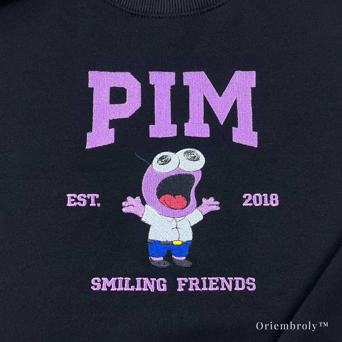 pink wide eyed cartoon embroidery close up