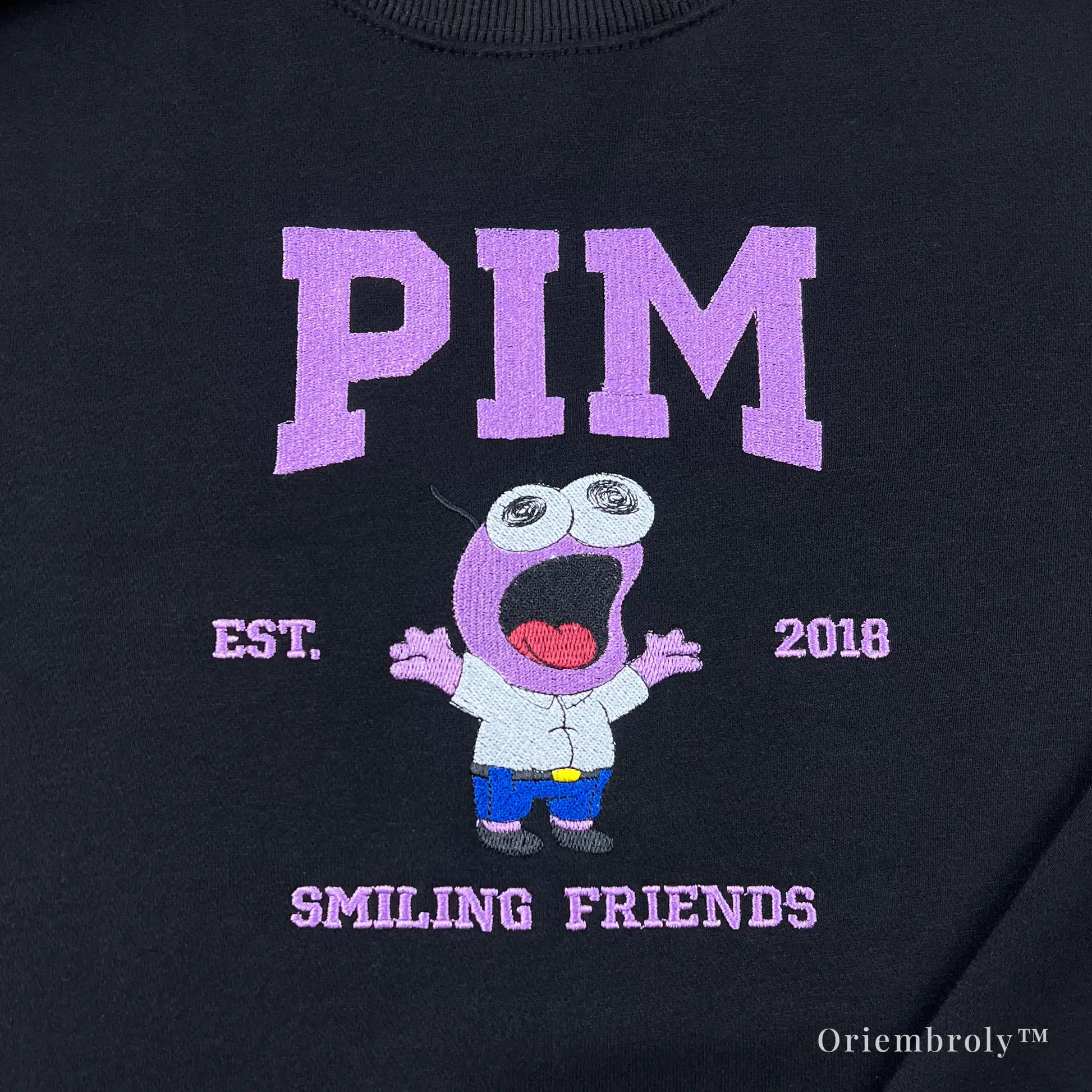 pink wide eyed cartoon embroidery close up