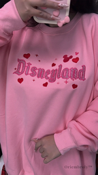Soft pastel pink sweatshirt with glitter embroidery, perfect for theme park fans and anyone who loves a little magic.