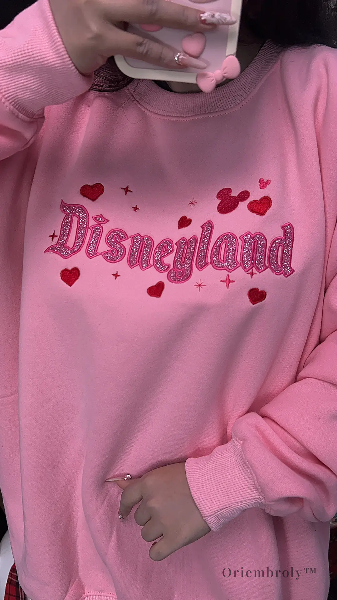 Soft pastel pink sweatshirt with glitter embroidery, perfect for theme park fans and anyone who loves a little magic.