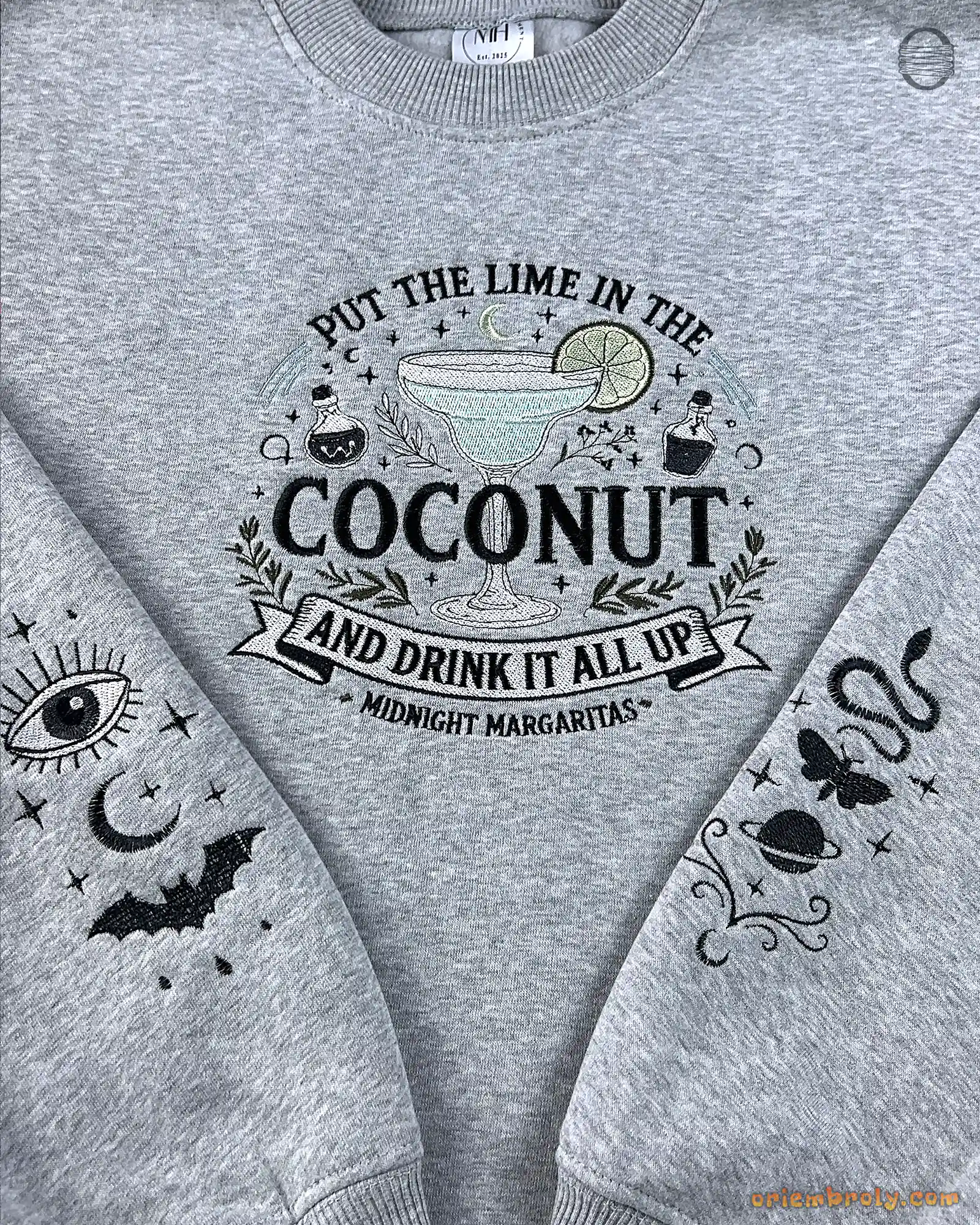Grey Practical Magic sweatshirt featuring coconut lime margarita graphic and celestial sleeve embroidery