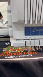 Video showing a computer embroidery machine actively stitching the Hagrid's Pumpkin Farm design on a black sweatshirt.