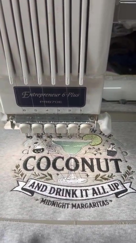 Video process of embroidering Put The Lime In The Coconut design on a grey crewneck sweatshirt