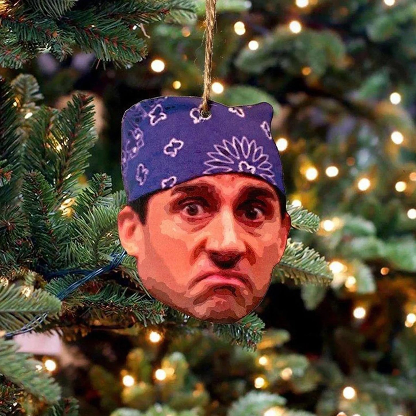 A 'Prison Mike' Christmas ornament featuring Michael Scott's face wearing a blue bandana, from The Office TV show merchandise. Perfect novelty or gag gift for fans.