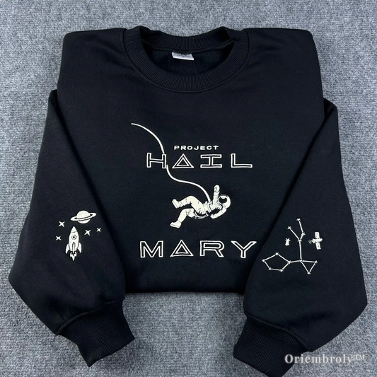 High-quality black crewneck sweatshirt with "Project Hail Mary" embroidery, featuring a floating astronaut and detailed constellation sleeve details. The perfect gift for Andy Weir sci-fi novel fans and book lovers